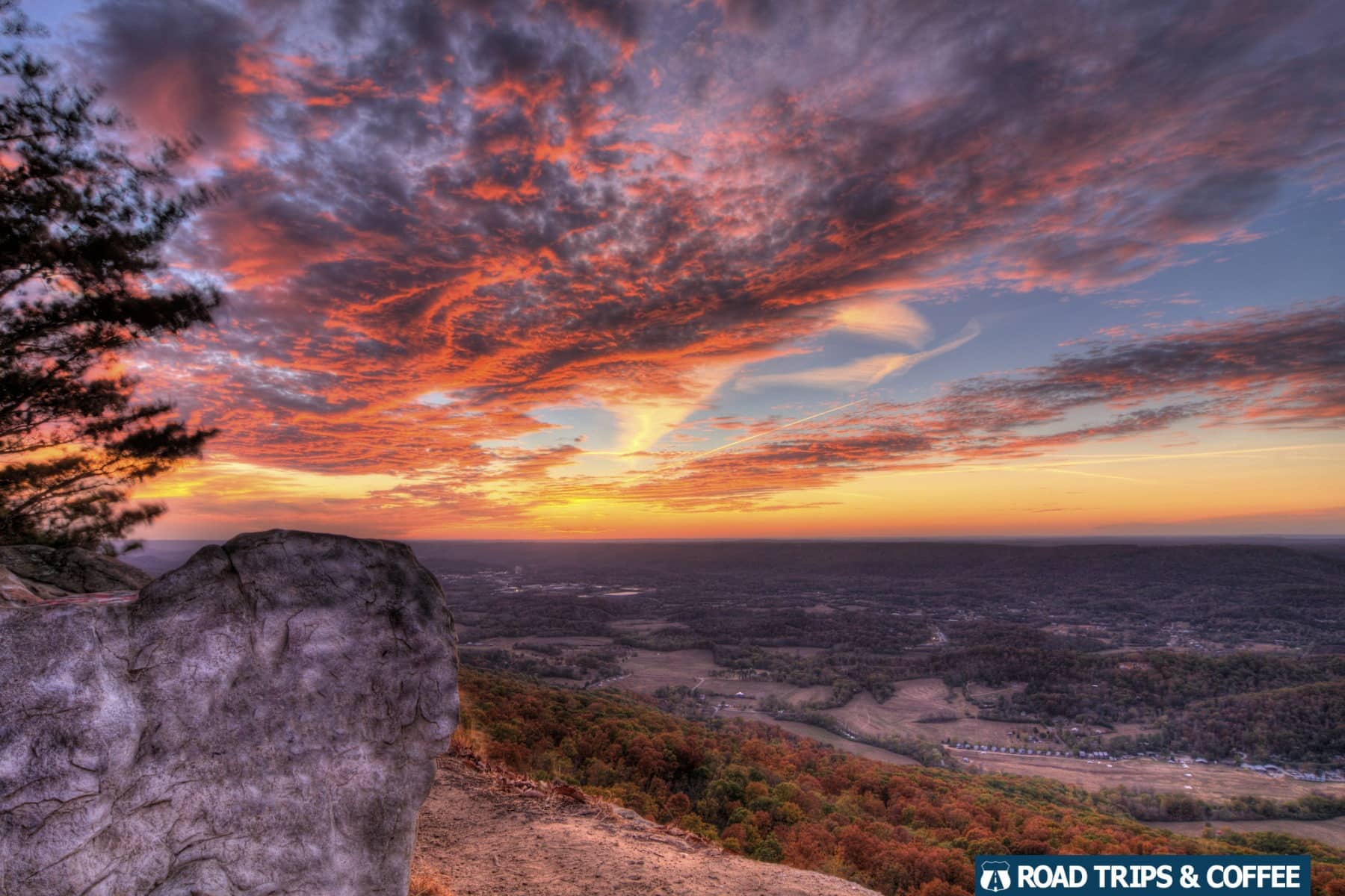 Warm oranges and pinks spread across the clouds during sunset in Lookout Mountain, Georgia