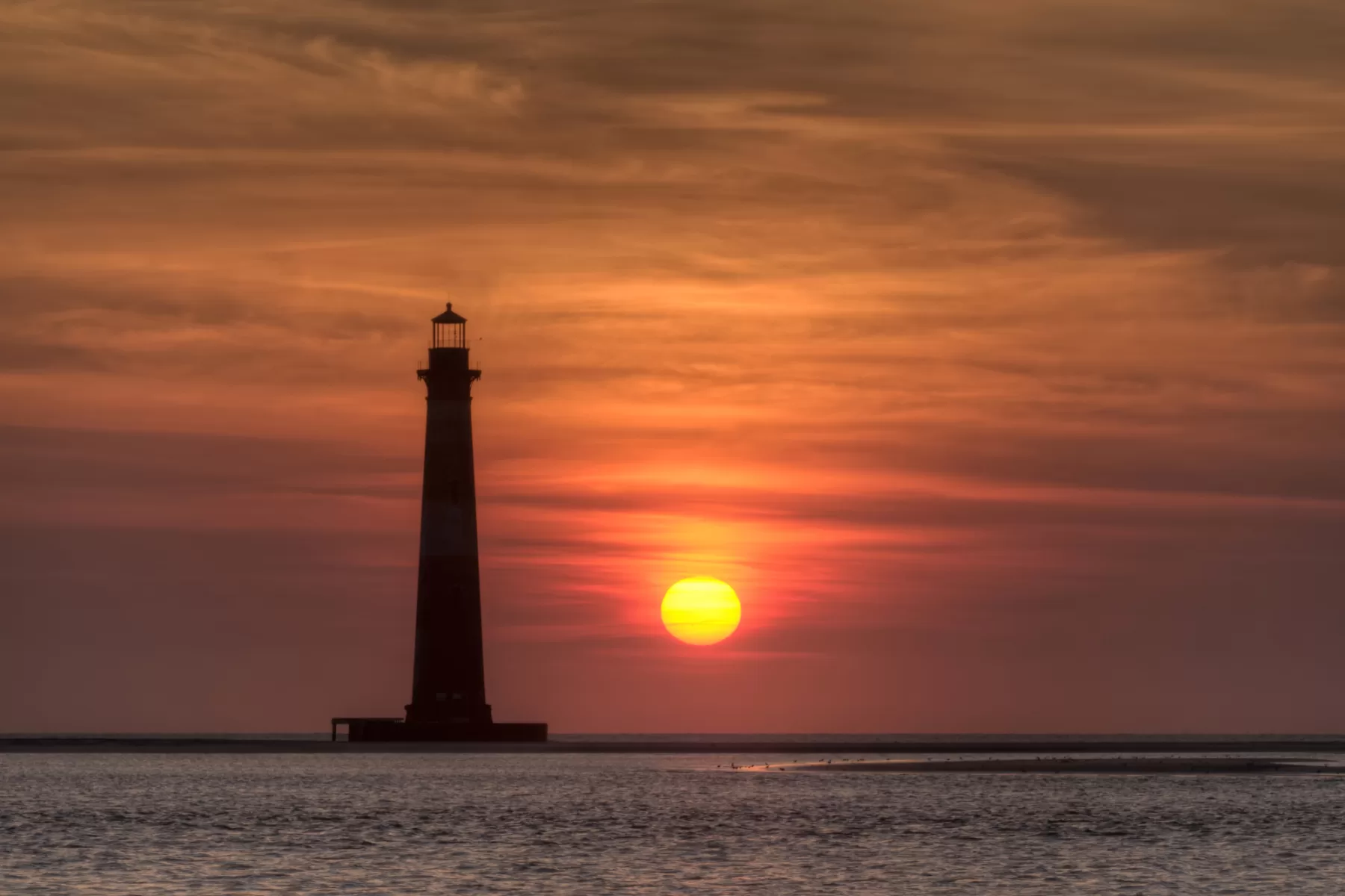 Sunrise behind the Morris Island Ligthhouse.